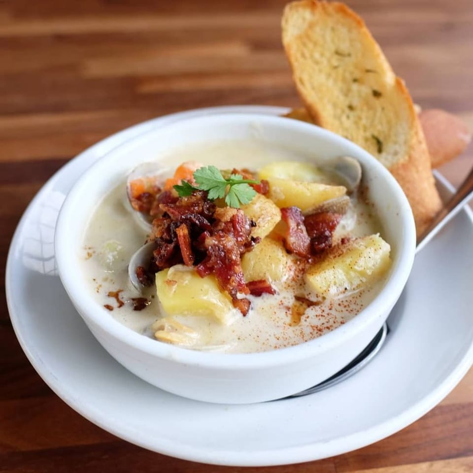 Kings Duck Bar&Grill's creamy clam chowder with potatoes, bacon, and parsley, served with toast.